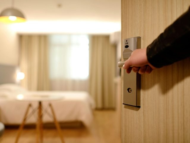 A soft-lit hotel room entrance, welcoming guests with luxury appeal and comfort.